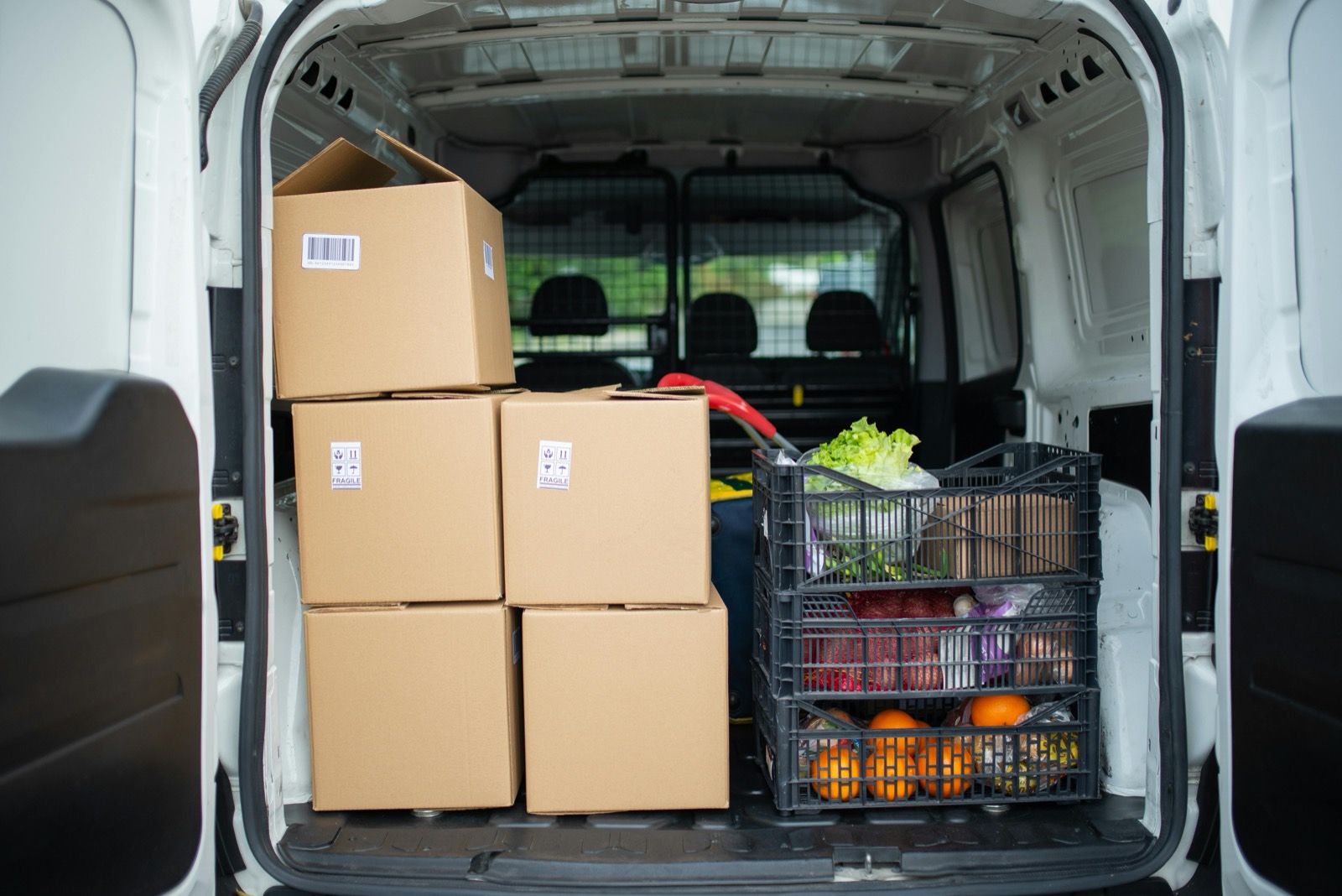 A van loaded with boxes of produce, black and white