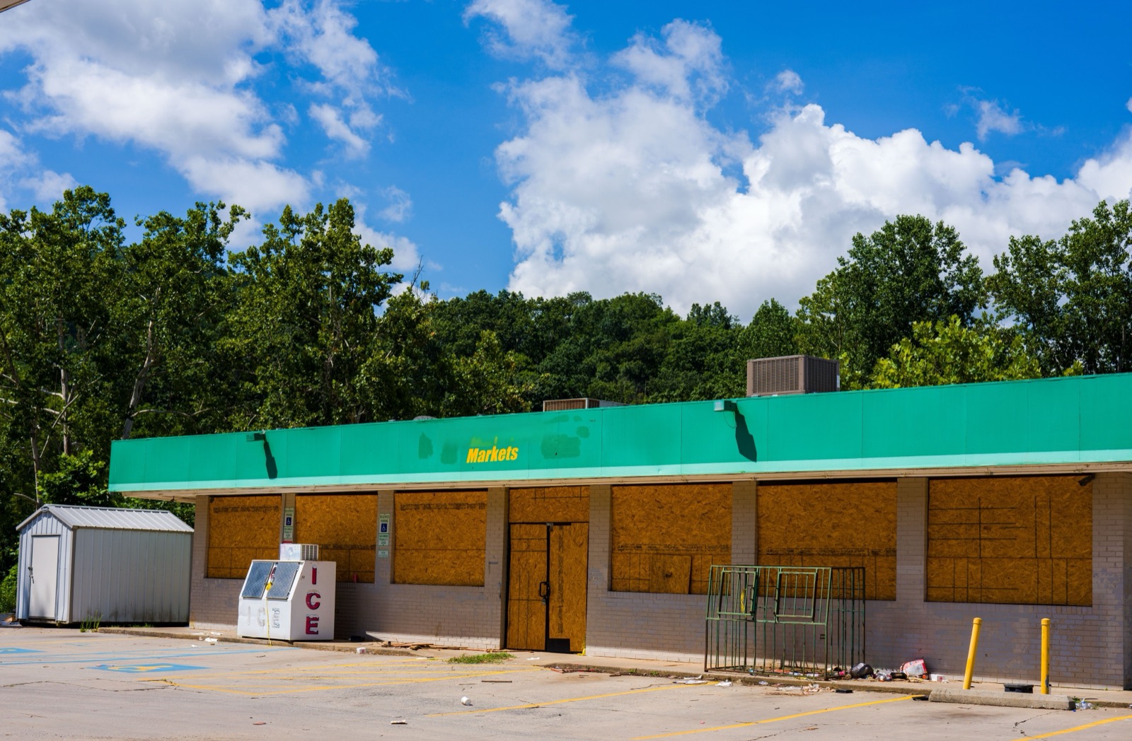 A closed grocery store and empty lot, black and white